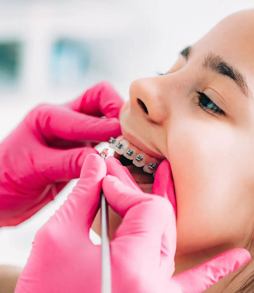 Orthodontist checking braces during a visit